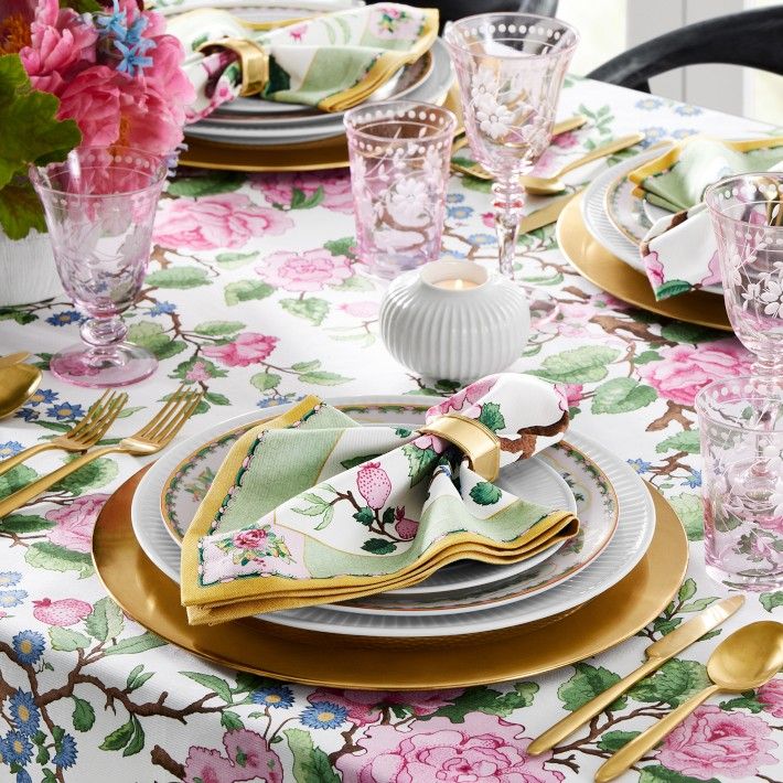 a table set with place settings and flowers