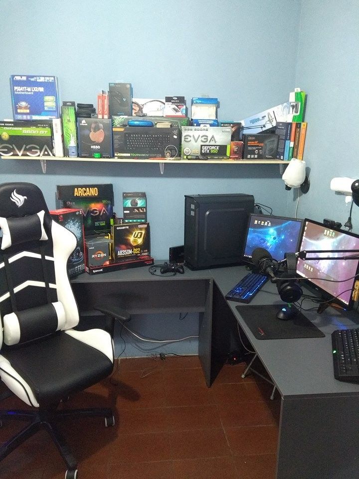 a room with two computer desks and several computers on the wall, along with other office supplies