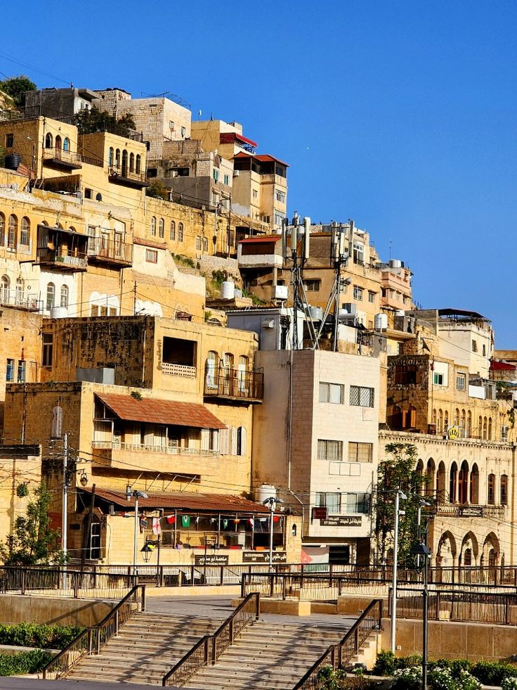 a city with lots of buildings and steps leading up to the top of each building