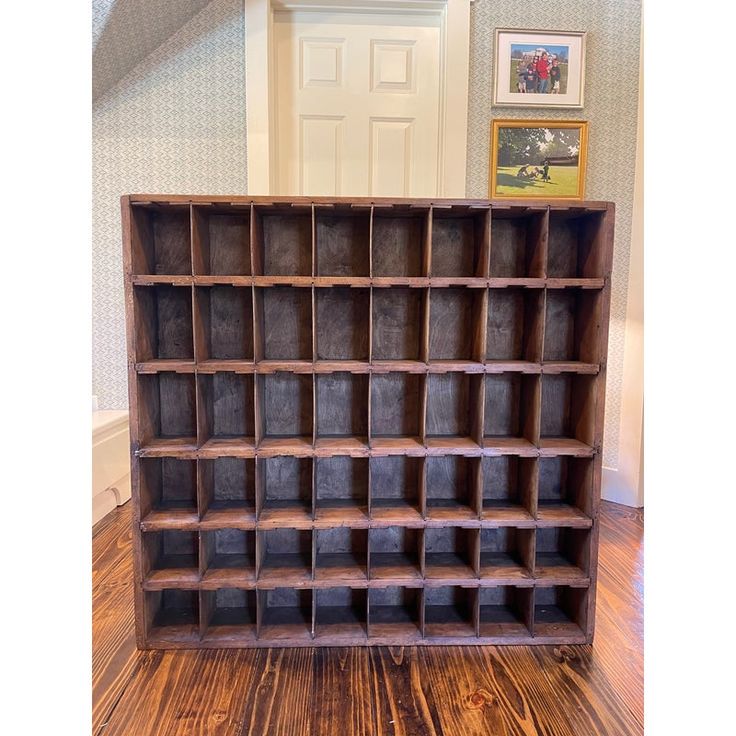 an old wooden bookcase with many compartments