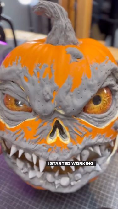 an orange and gray pumpkin with teeth painted on it's face that says, i started working