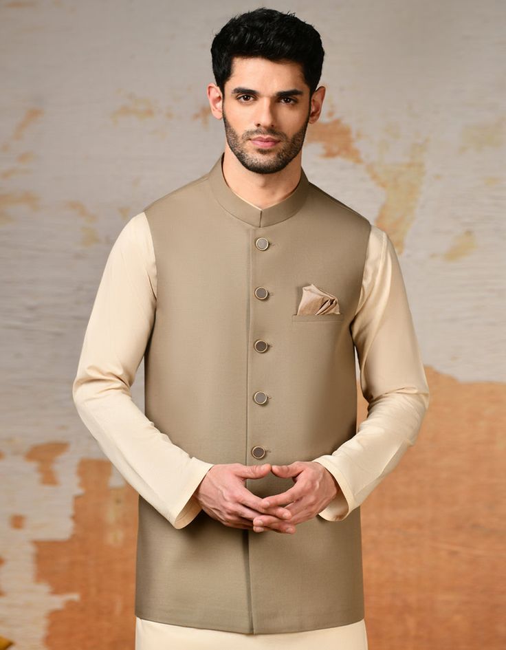 Elevate your traditional attire with this Beige blended waistcoat, a timeless piece that adds sophistication to your look. Crafted with meticulous attention to detail, it features a classic design that complements any kameez shalwar or kurta. Perfect for weddings, festive occasions, or cultural events, this waistcoat i Elegant Sleeveless Designer Kurta, Elegant Sleeveless Designer Traditional Wear, Festive Fitted Salwar Kameez For Semi-formal Occasions, Elegant Unstitched Sleeveless Sets, Classic Bandhgala For Workwear And Festive Occasions, Classic Bandhgala For Festive Workwear, Classic Festive Bandhgala For Workwear, Classic Unstitched Traditional Wear For Formal Occasions, Classic Bandhgala With Stand Collar For Festive Occasions