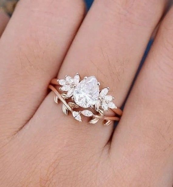 a woman's hand with a ring on it and a diamond in the middle