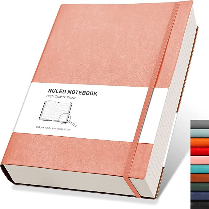 a pink notebook sitting next to a stack of colored papers on top of each other