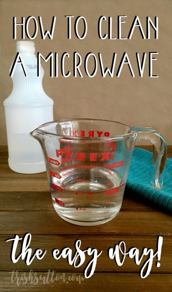 a glass measuring cup filled with liquid and the words how to clean an microwave on it