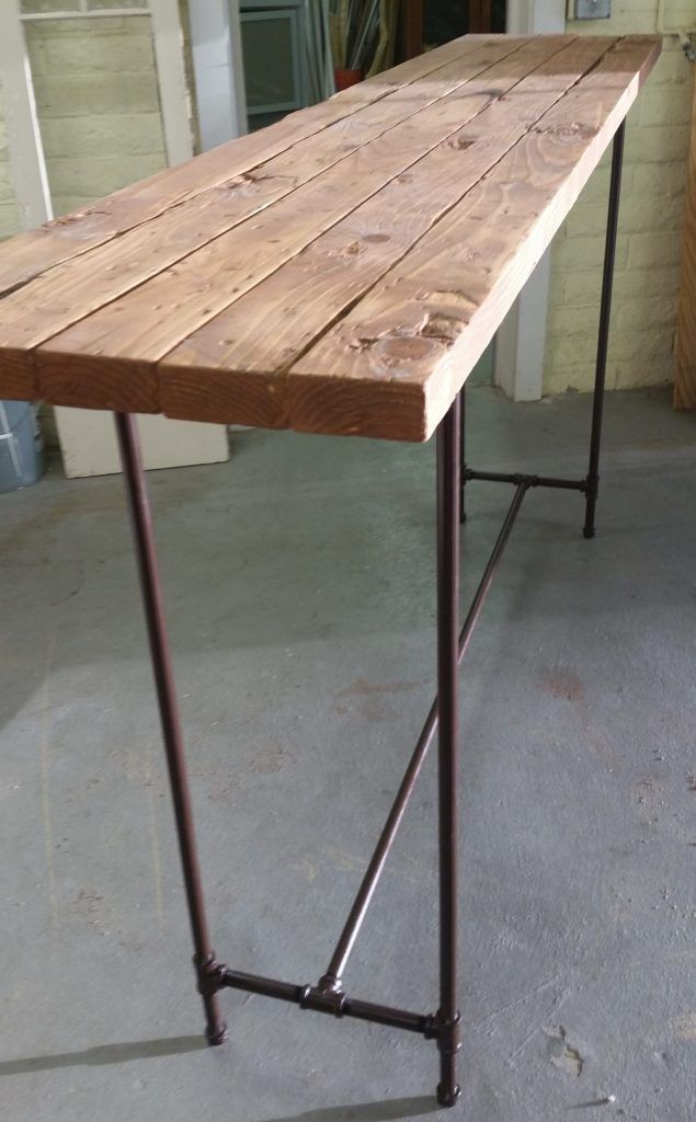 a wooden table sitting on top of a cement floor