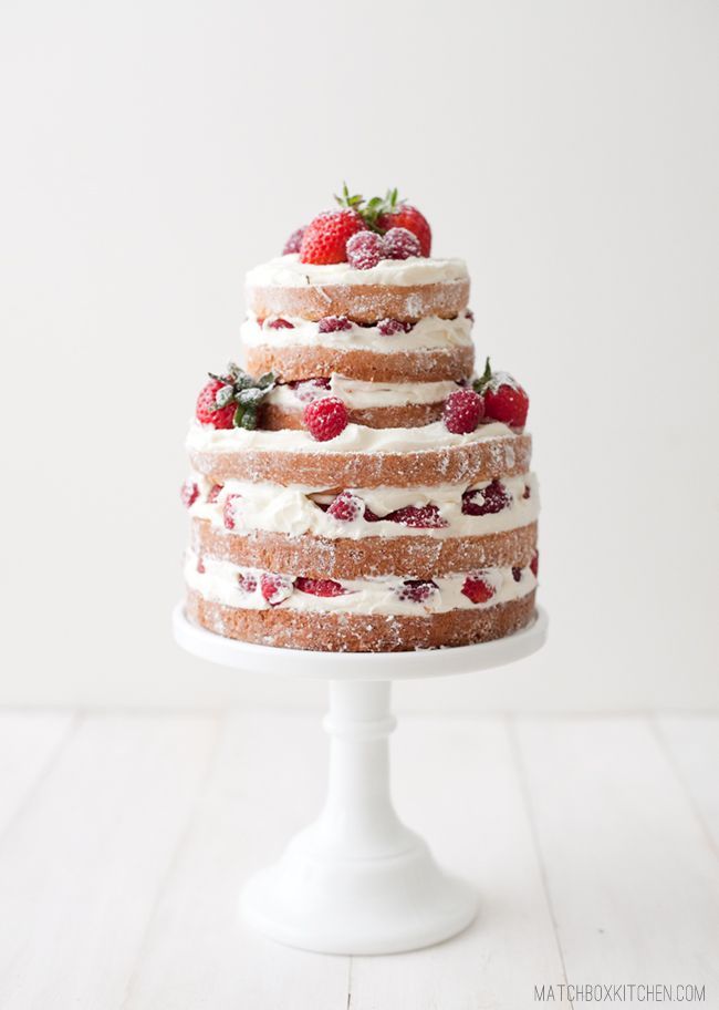 a three layer cake with strawberries on top