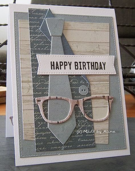 a happy birthday card with glasses and a tie on the front, sitting on a table