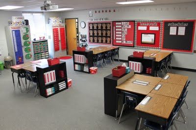 an empty classroom with desks, chairs and bulletin boards on the wall in front of them