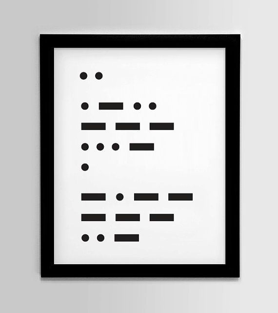 a black and white framed art print with dots in the middle, on a gray wall