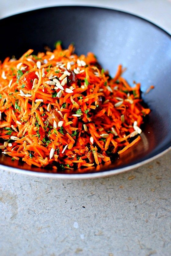 a bowl filled with shredded carrots on top of a table