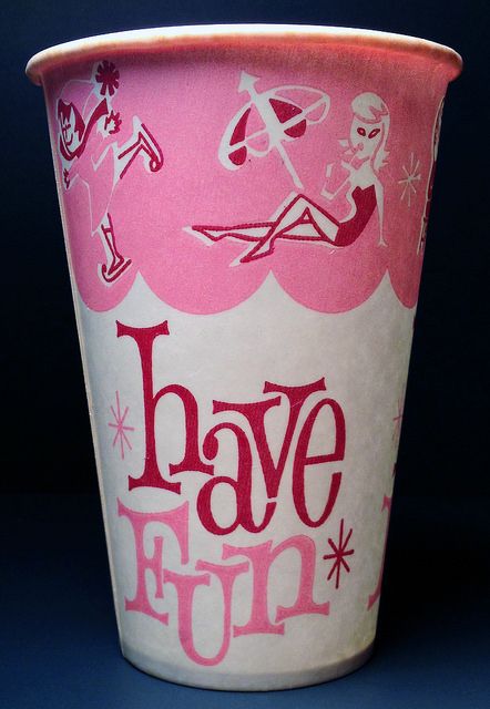 a pink and white cup with the words have fun written in red ink on it