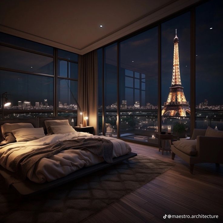 a bedroom with a view of the eiffel tower in paris, france at night