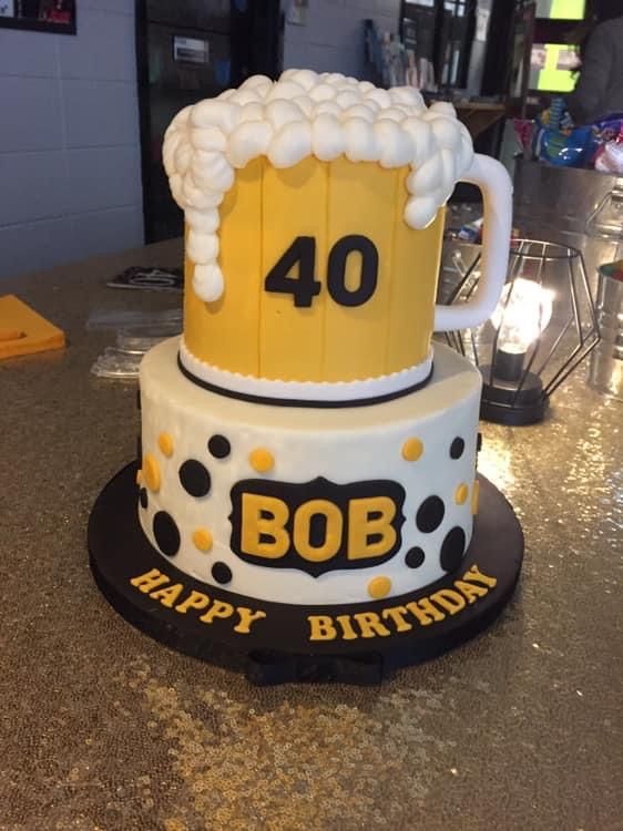 a birthday cake made to look like a beer mug with the number 40 on it