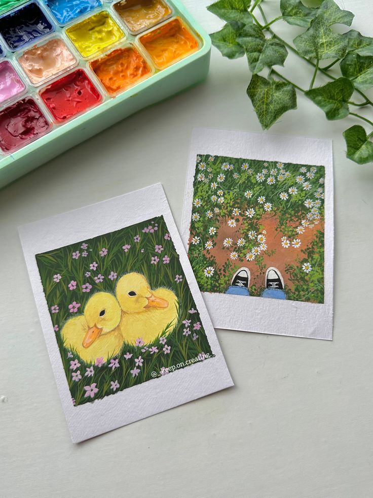 two pictures of ducks sitting next to each other on a table with paint and crayons in the background