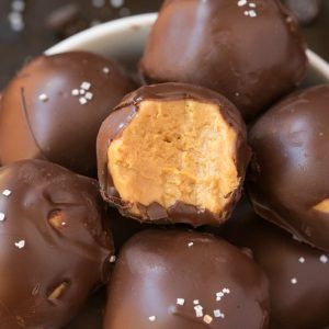 chocolate peanut butter no bake balls in a bowl with text overlay that reads, 4 ingredient keto vegan chocolate peanut butter no bake balls