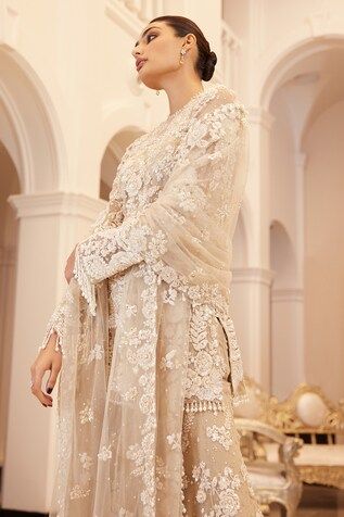 Beige sheer kurta with floral embroidery using sequins, beads and thread work. Comes with a sharara with all over floral bloom embroidery and floral embroidered dupatta. - Aza Fashions Wedding Palazzo Set With Cutdana For Eid, Elegant Designer Lace Work Sets, Elegant Cream Sharara With Sheer Dupatta, Diwali Lace Work Sharara For Reception, Reception Sharara With Lace Work, Wedding Cream Palazzo Set With Chikankari Embroidery, Diwali Reception Sharara With Lace Work, Elegant Palazzo Set With Chikankari Embroidery For Reception, Elegant Palazzo Set With Sheer Dupatta For Reception