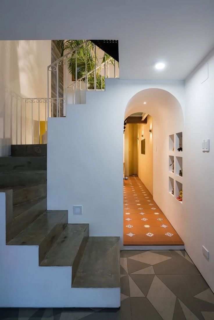 an entry way with stairs and tiled flooring