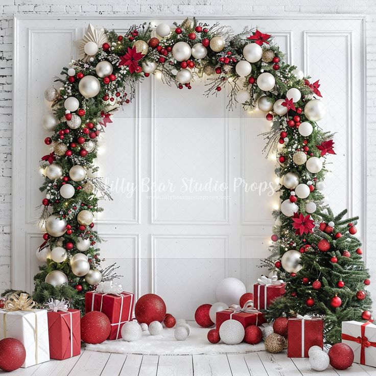 christmas decorations and presents are arranged in an arch