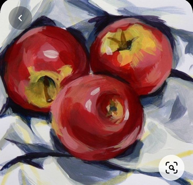 three apples are sitting on a white cloth