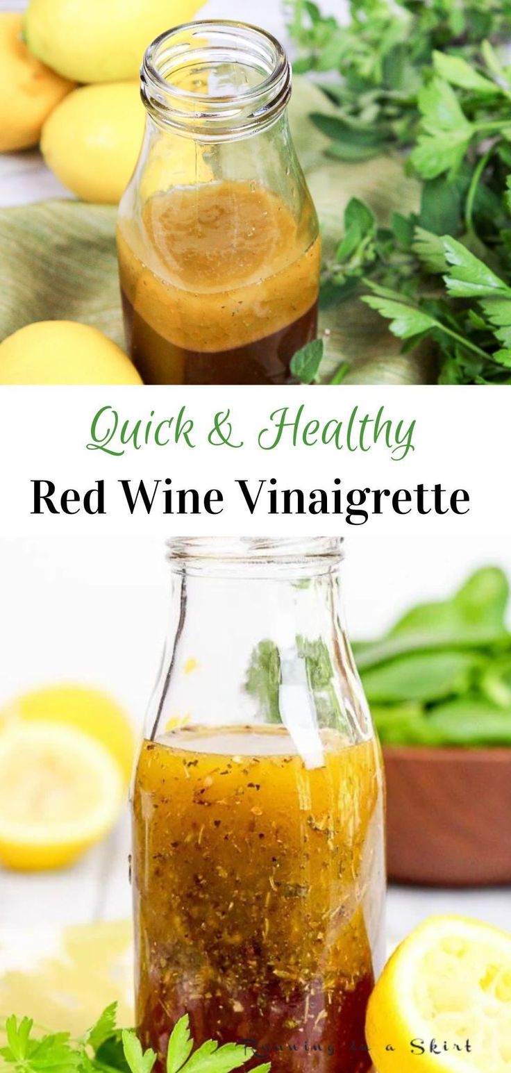 a bottle filled with red wine vinegar next to lemons and herbs