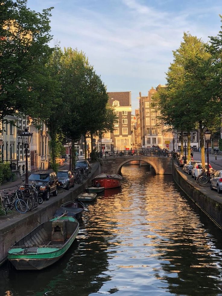 boats are parked along the side of a canal