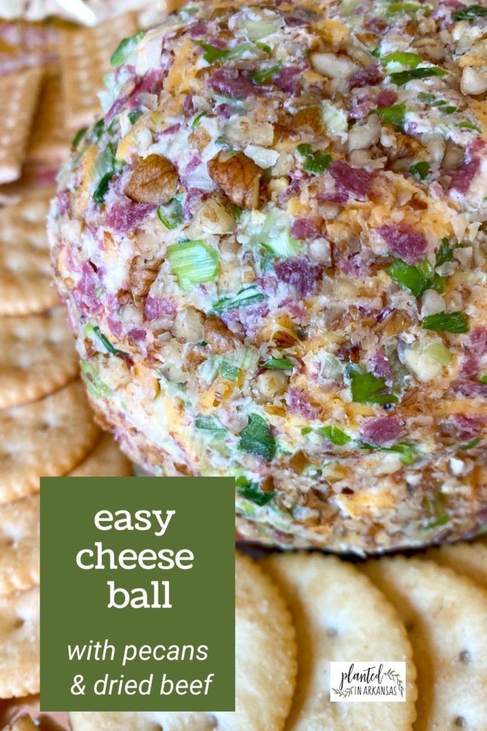 an easy cheese ball with pecans and dried beef on top, surrounded by crackers