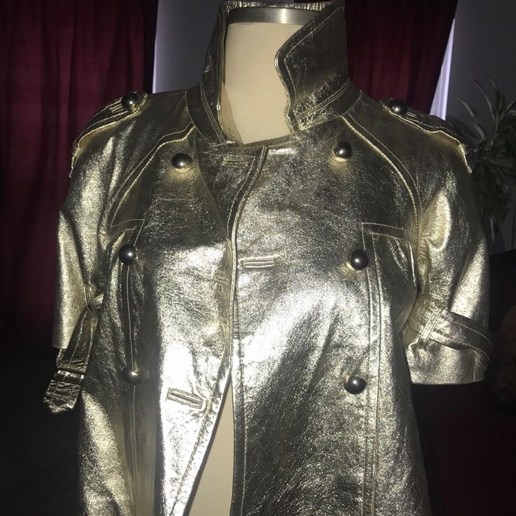 Gold Jocelyn Leather Jacket With Short Sleeves, Falls Right Above Elbow. Adjustable Straps On Arms , And Gold Button Front Closure. Small Knick On Upper Right Leather, View Last Picture. Size Medium, But Fits More Like A Small Size 6 . Purchased From Neiman Marcus. Great Condition. Luxury Gold Double-breasted Outerwear, Luxury Gold Outerwear With Buttons, Designer Gold Blazer With Button Closure, Luxury Double-breasted Leather Jacket For Spring, Luxury Double-breasted Spring Leather Jacket, Gold Outerwear With Button Closure For Fall, Luxury Spring Double-breasted Leather Jacket, Designer Gold Outerwear With Buttons, Gold Double-breasted Outerwear For Fall