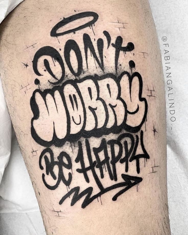 a man's arm with black ink that says don't worry be happy