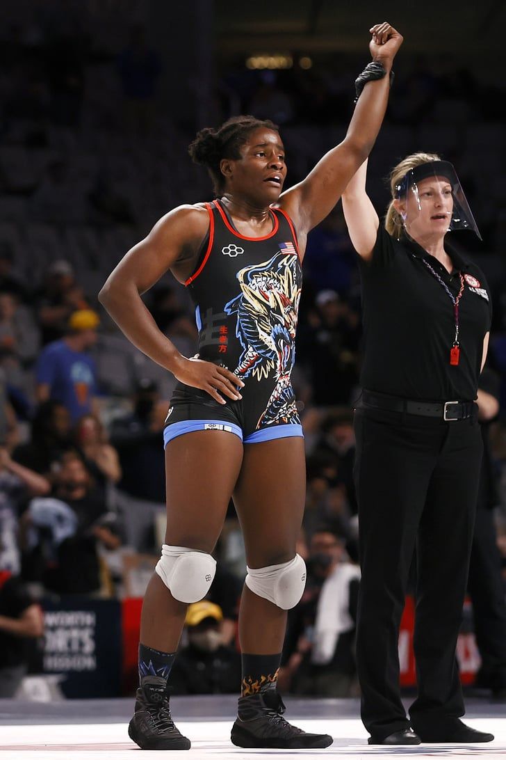 a woman is holding her fist up as she stands next to an umpire on the court