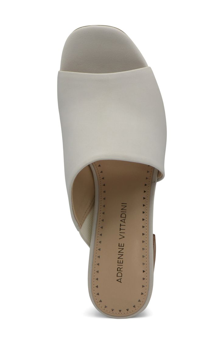 An asymmetrical strap creates a unique touch on this classic open toe mule. 3.5" heel Open toe Asymmetrical vamp Slip-on Block heel Manmade upper, lining, and sole Imported Formal Slip-on Sandals With Deep Heel Cup, Modern Open Toe Mules For Evening, Modern Open Toe Mules With Wrapped Heel, Chic Open Toe Heels With Removable Insole, Classic Synthetic Mules For Evening, Evening Synthetic Mules With Stacked Heel, Evening Synthetic Mules With Almond Toe, Chic Slip-on Sandals For Formal Occasions, Modern Open Toe Mules With Heel Strap