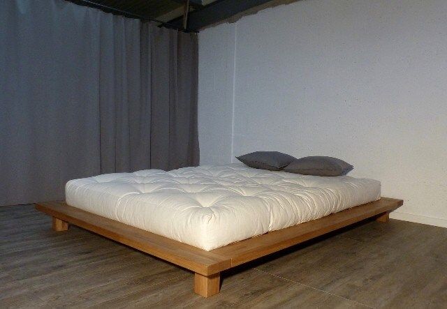 a bed that is on top of a wooden platform