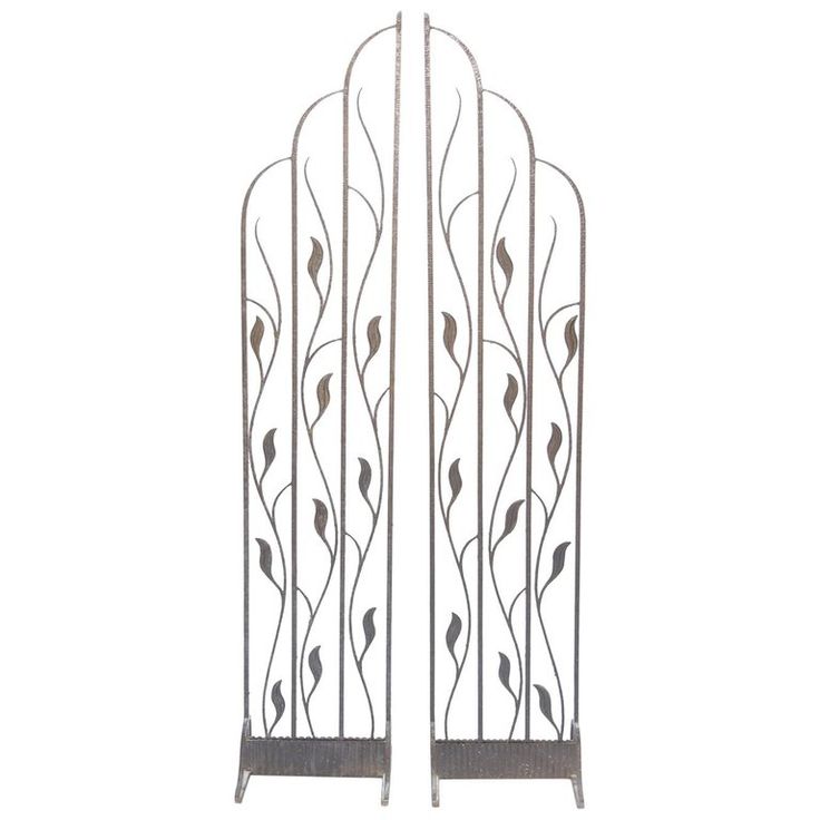 two metal gates with leaves on them against a white background, one is open and the other has closed