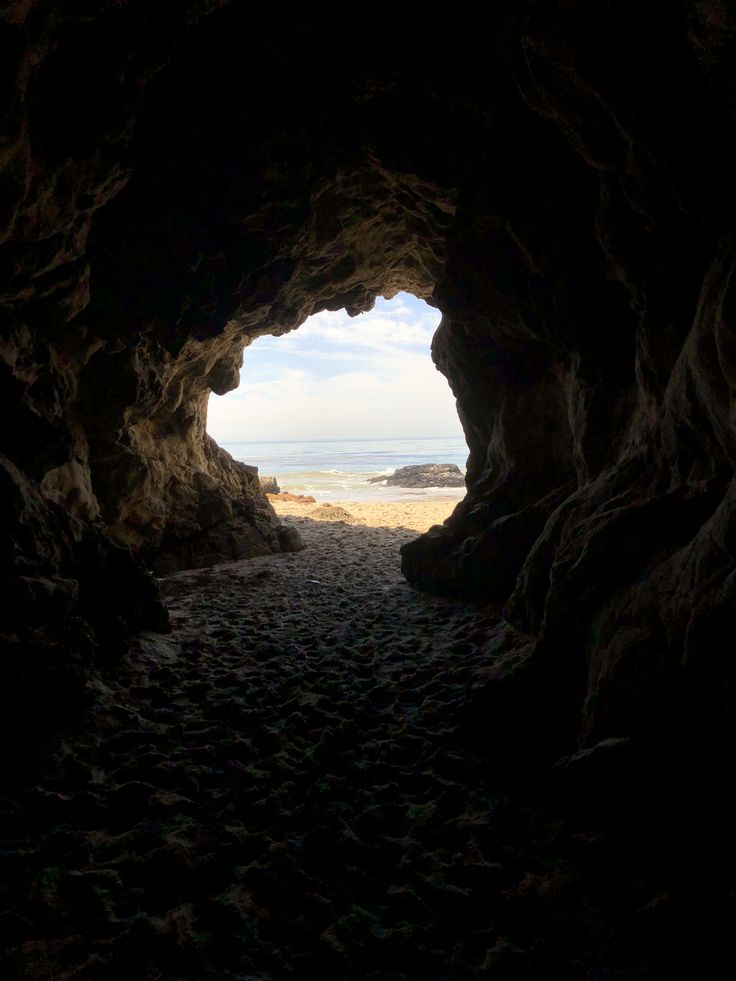 the light at the end of the tunnel shines brightly in the distance as it enters the beach