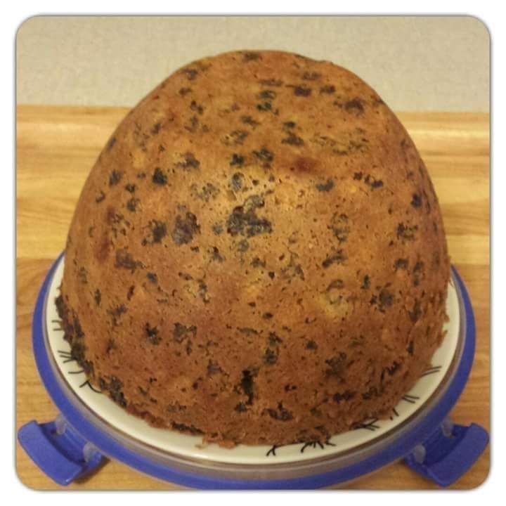 a cake sitting on top of a blue and white plate with a measuring tape around it