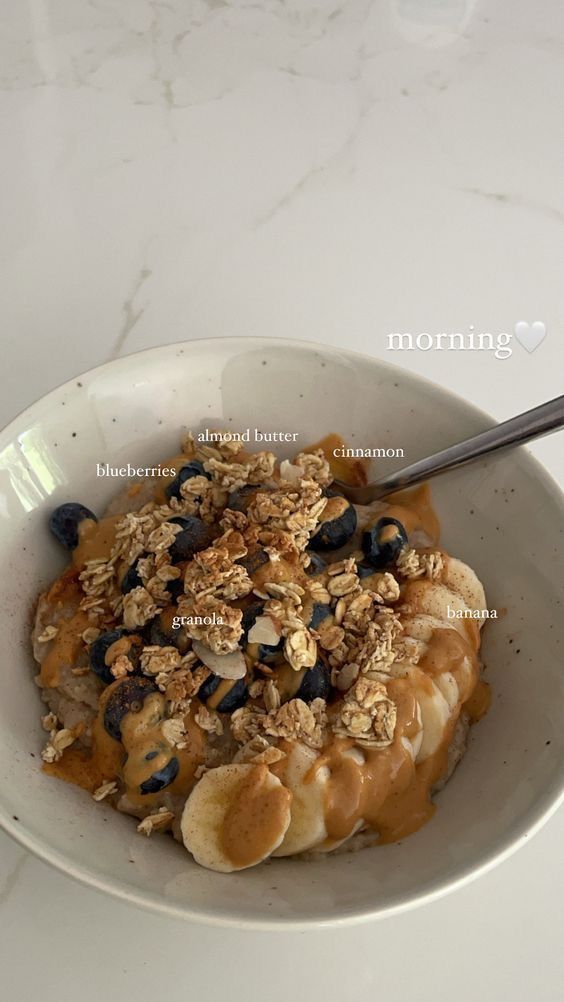 a bowl filled with oatmeal and blueberries on top of a table