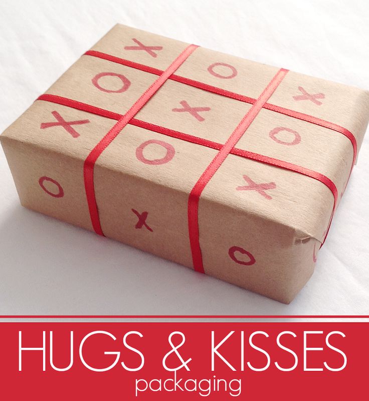 a box wrapped in brown paper with red ribbon and the words hugs & kisses on it