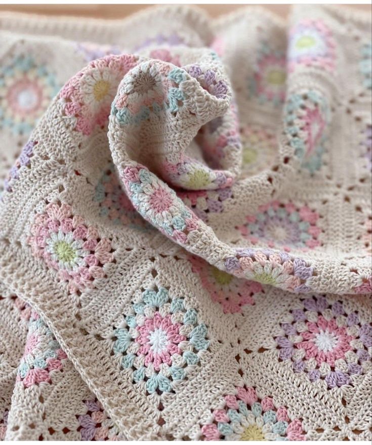 a crocheted blanket with flowers on it