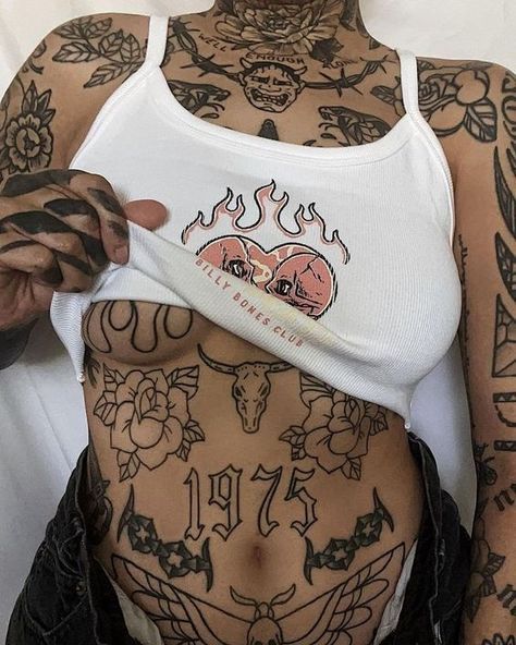 a woman with tattoos on her stomach and arms