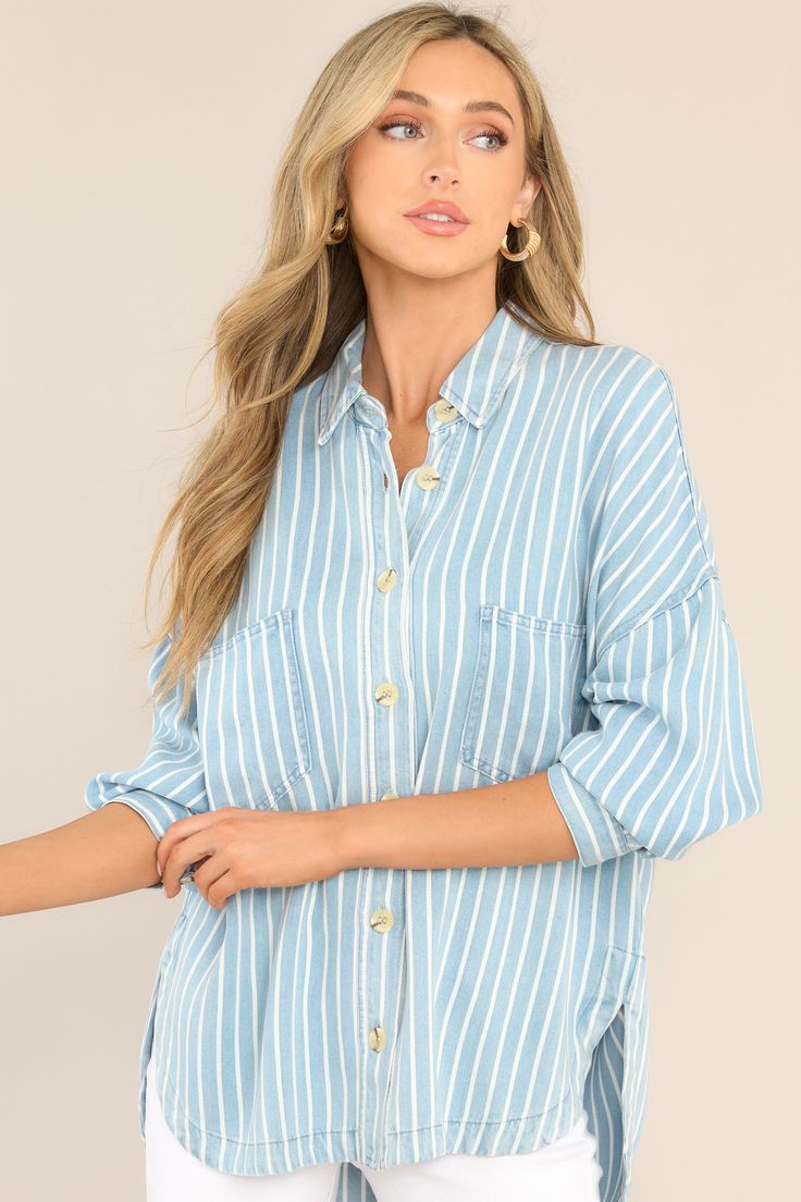 Looking for an effortless classic? This Always Lovely Blue Striped Top is your go-to for effortless, casual style. Throw it on and get ready for the compliments! This top features a collared neckline, functional buttons down the front, two functional bust pockets, long sleeves with buttoned cuffs, a scoop bottom hem, and a super soft material. 100% Lyocell Hand Wash Cold Unlined Imported Model is wearing a small Blue Tops With Roll-up Sleeves For Spring, Blue Tops With Roll-up Sleeves For Daywear, Chic Light Wash Tops With Buttons, Chic Light Wash Top With Button Closure, Chic Light Wash Button-up Tops, Trendy Blue Top With Collared Neckline, Light Wash Button Top For Day Out, Light Wash Buttoned Tops For Day Out, Light Wash Long Sleeve Tops With Buttoned Pockets