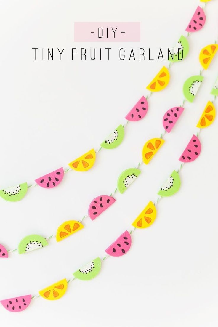 the diy tiny fruit garland is hanging from a string with watermelon slices on it