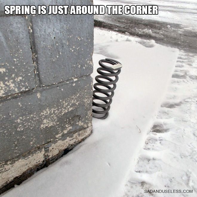 a spring that is sitting in the snow next to a building with words saying, spring is just around the corner