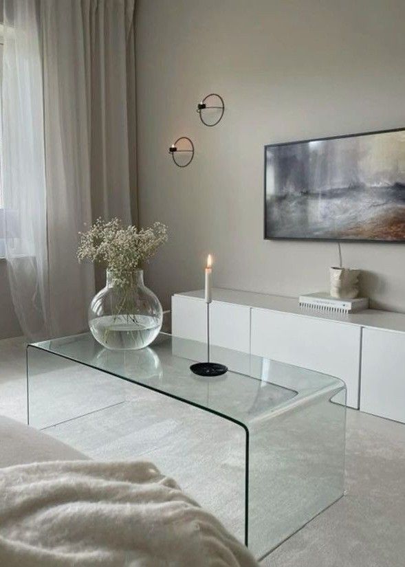 a living room with a glass coffee table