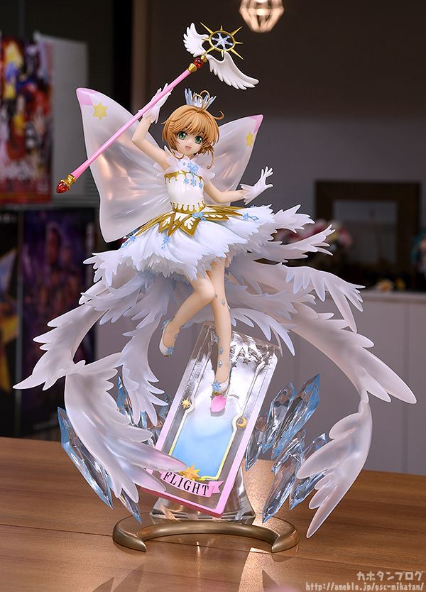 a glass figurine with an angel holding a wand and standing on top of a table