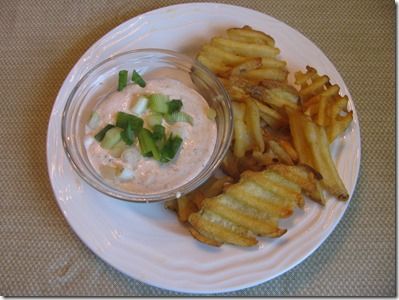 a white plate topped with french fries and dip