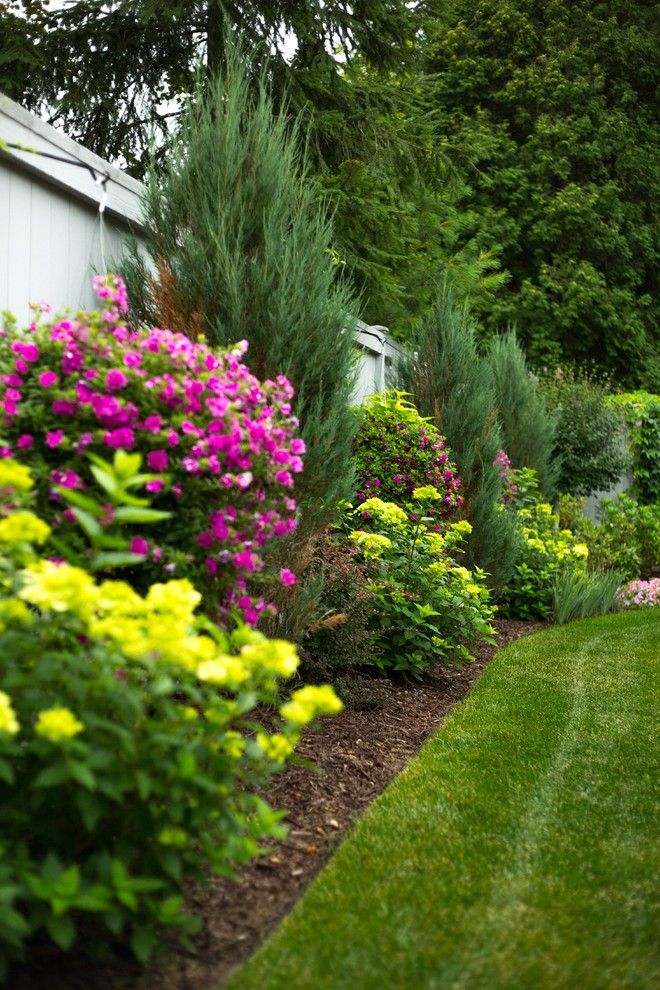 the garden is full of colorful flowers and trees