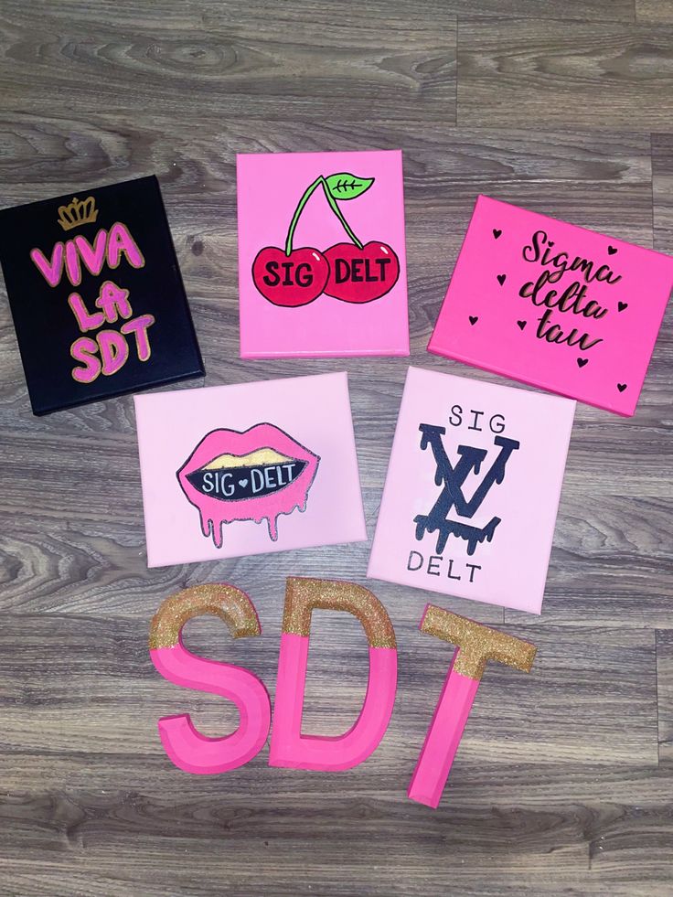 some stickers and magnets on top of a wooden floor with the word sdt spelled out