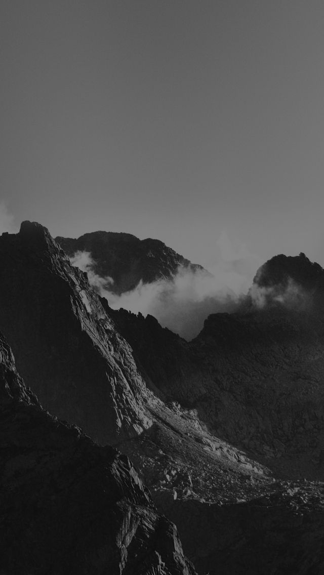 black and white photograph of mountains with clouds