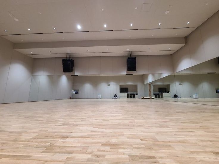 an empty dance hall with speakers on the ceiling