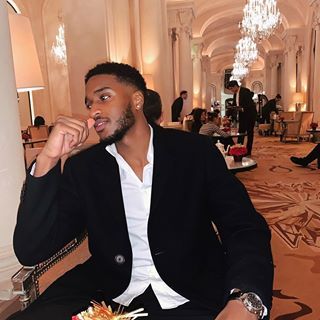 a man in a suit sitting down at a table